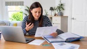 UK parent preparing documents and payment details before calling the Child Benefit helpline.